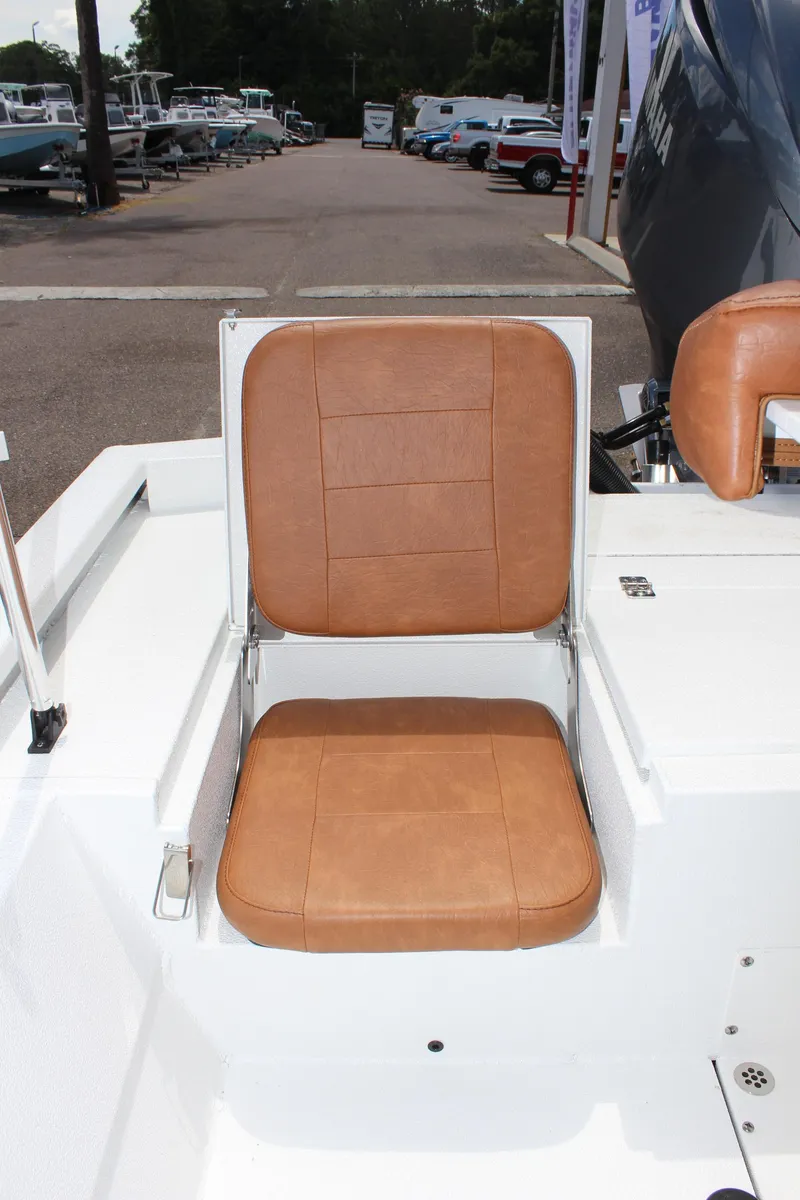 Slide: The Image of 2024 Avid 21 Fusion boat with tan leather seat in marina. - 12
