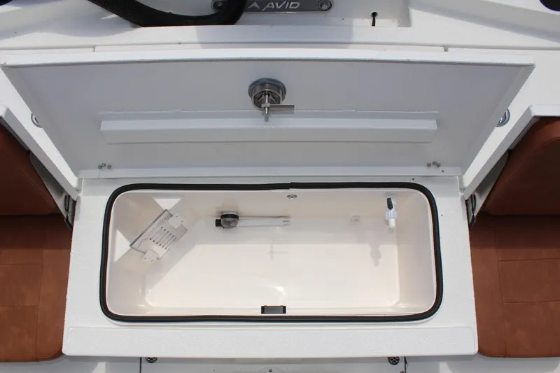 Slide: The Image of Open storage compartment of 2024 Avid 21 Fusion boat with white interior. - 14