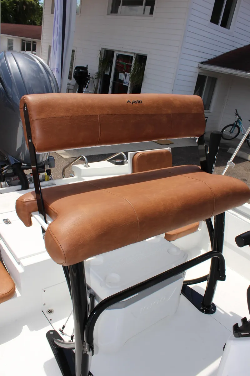 Slide: The Image of 2024 Avid 21 Fusion boat with brown leather seating and black frame. - 15