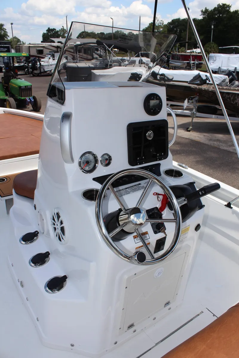 Slide: The Image of 2024 Avid 21 Fusion boat console with steering wheel and controls. - 16