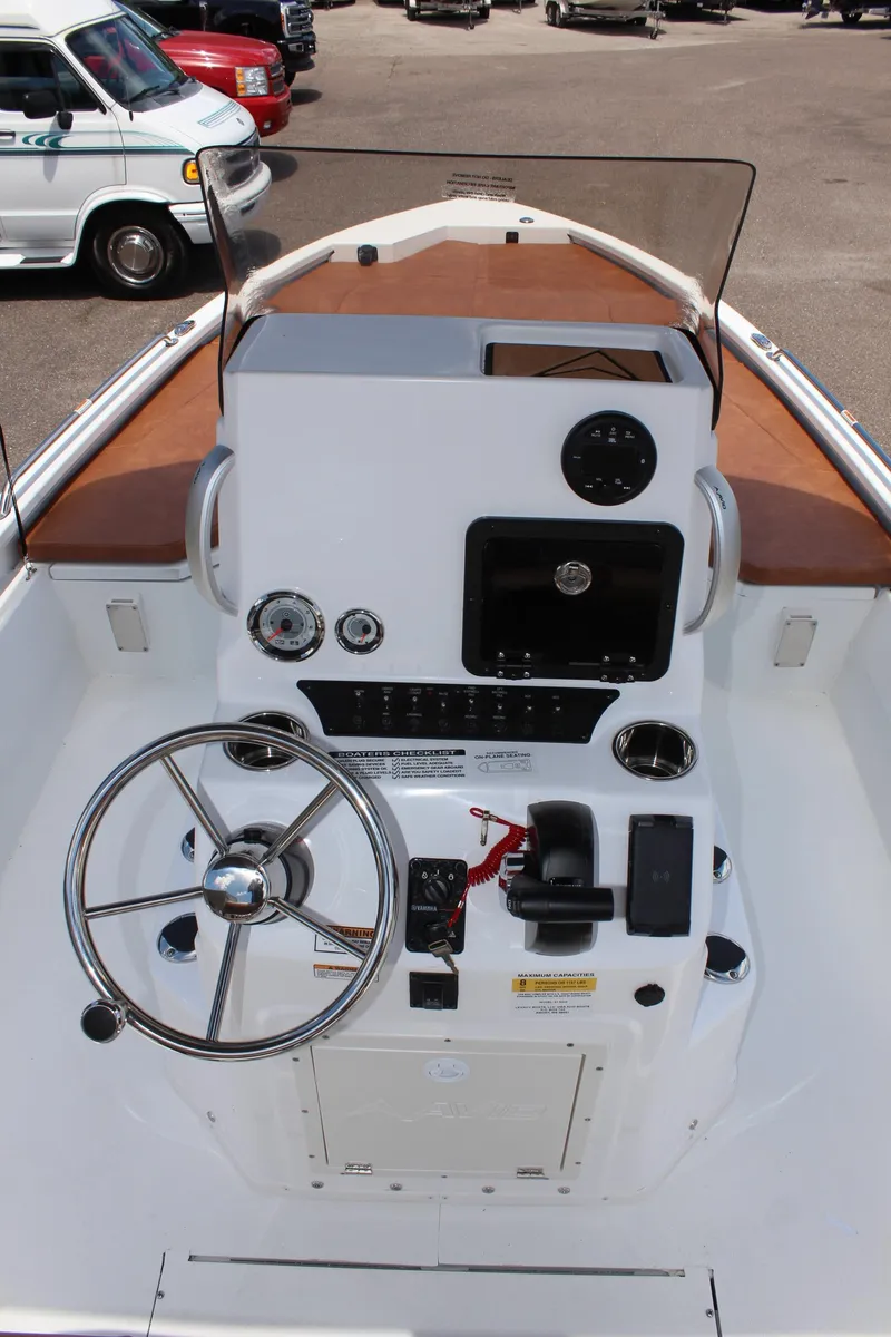 Slide: The Image of 2024 Avid 21 Fusion boat console with steering wheel and navigation controls. - 17