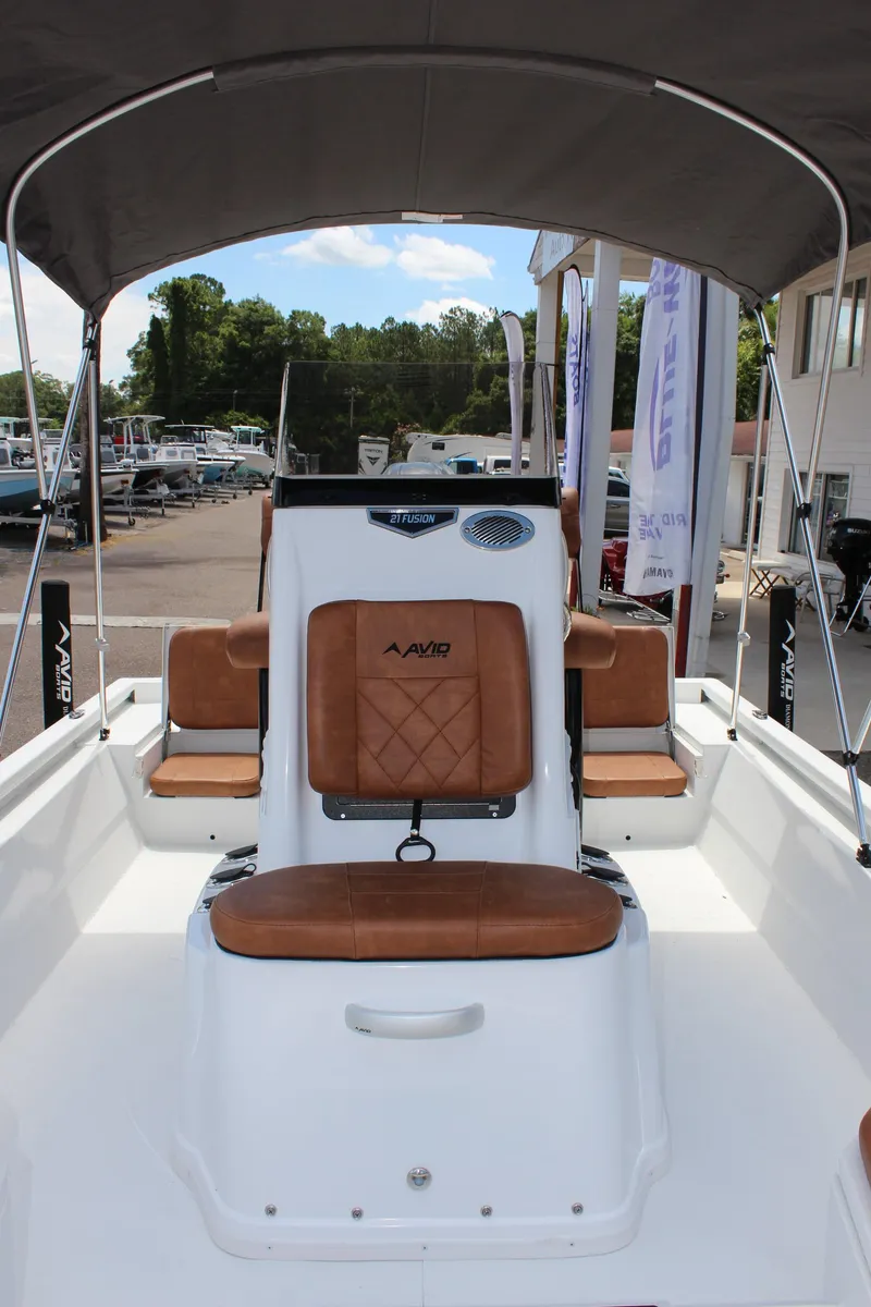 Slide: The Image of 2024 Avid 21 Fusion boat with brown leather seats and canopy. - 19