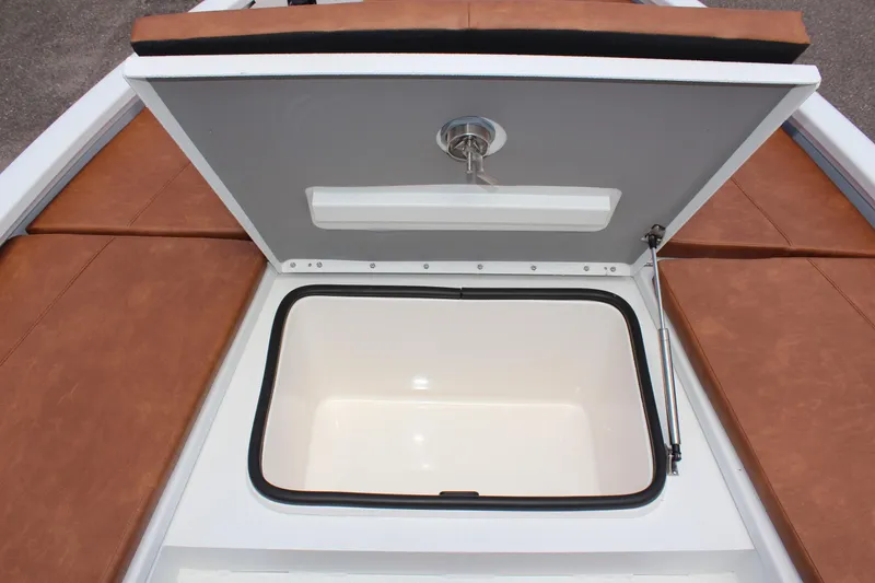 Slide: The Image of 2024 Avid 21 Fusion boat storage compartment with open lid. - 25