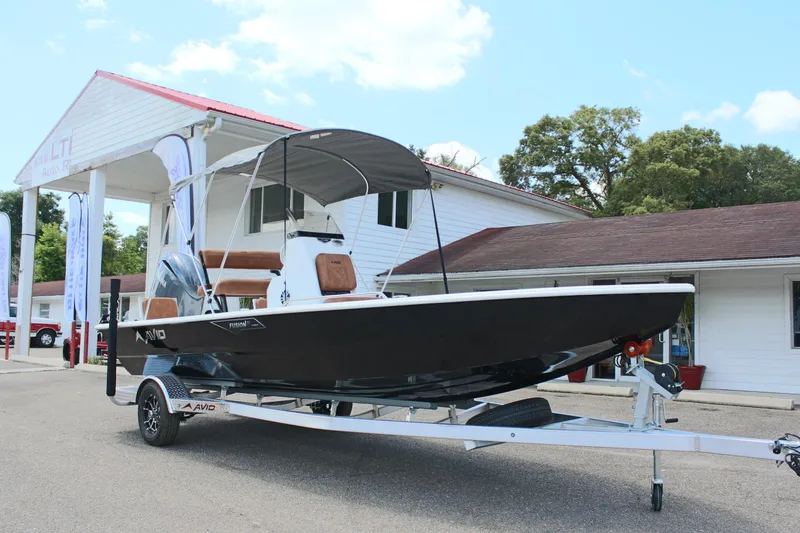 Slide: The Image of 2024 Avid 21 Fusion boat on a trailer outside a dealership. - 4