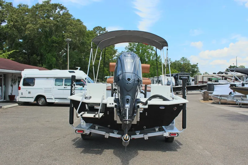Slide: The Image of 2024 Avid 21 Fusion boat with outboard motor, parked in a marina. - 7