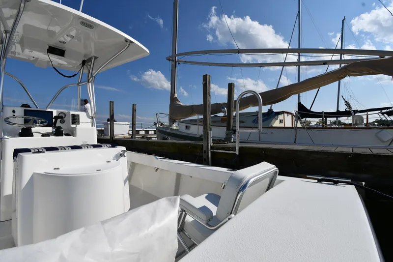 Slide: The Image of 2021 Eastern 248 Center Console boat docked at a marina on a sunny day. - 14