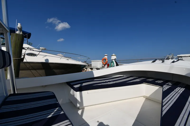 Slide: The Image of 2021 Eastern 248 Center Console boat docked with striped seating and clear blue sky. - 22