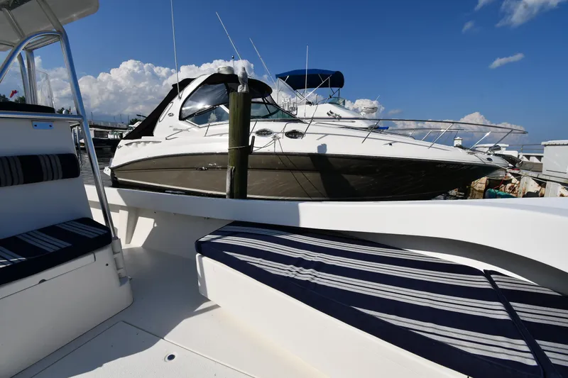 Slide: The Image of 2021 Eastern 248 Center Console boat docked at marina with clear blue sky. - 24