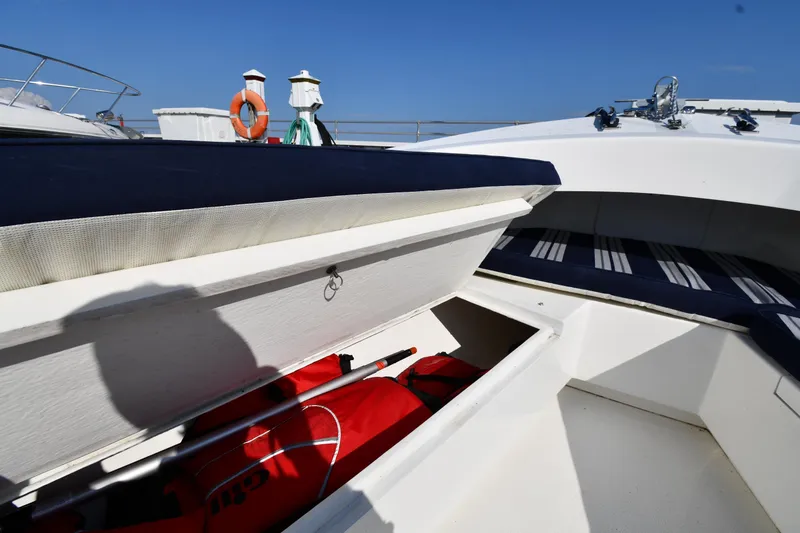 Slide: The Image of 2021 Eastern 248 Center Console boat with open storage compartment and life jackets. - 26
