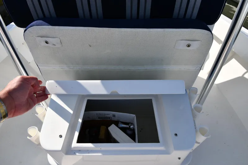 Slide: The Image of 2021 Eastern 248 Center Console boat storage compartment with open lid. - 28