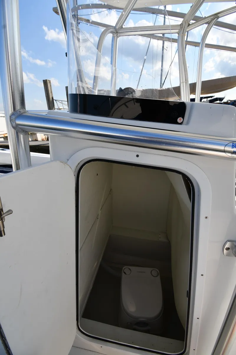 Slide: The Image of 2021 Eastern 248 Center Console boat with an open cabin door showing the interior. - 30