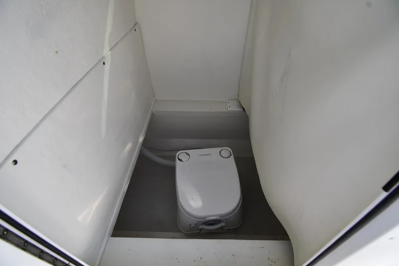 Slide: The Image of 2021 Eastern 248 Center Console boat interior with portable toilet. - 31