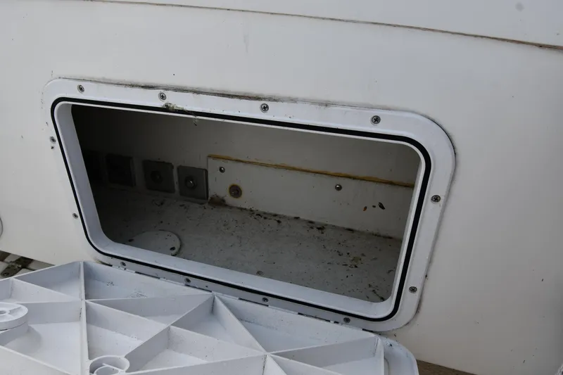 Slide: The Image of Open storage compartment on a 2021 Eastern 248 Center Console boat. - 34