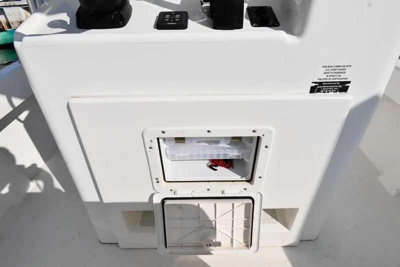 Slide: The Image of 2021 Eastern 248 Center Console boat storage compartment and control panel. - 35