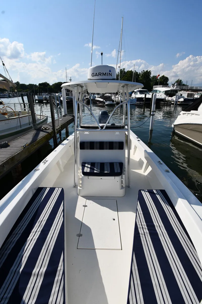Slide: The Image of 2021 Eastern 248 Center Console boat docked at a marina with Garmin equipment. - 5