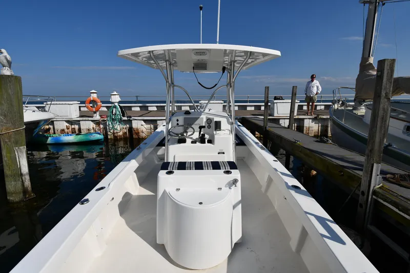 Slide: The Image of 2021 Eastern 248 Center Console boat docked at a marina on a sunny day. - 6