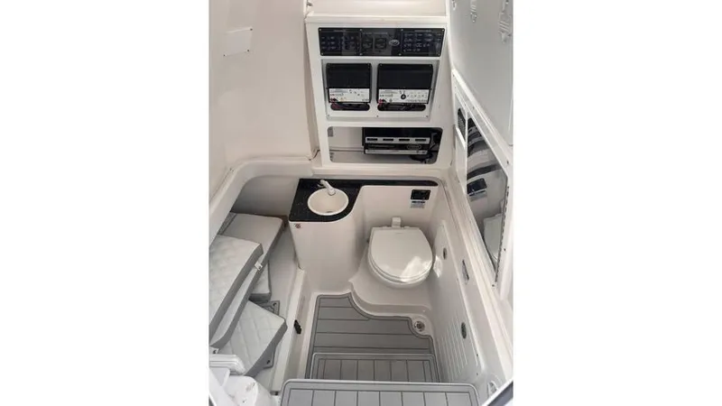 Slide: The Image of 2025 Sea Fox 328 Commander boat interior with toilet and control panels. - 12