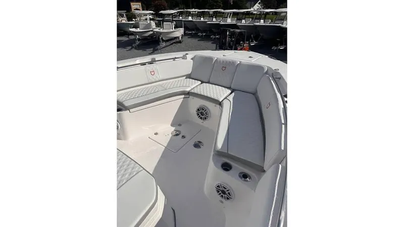 Slide: The Image of 2025 Sea Fox 328 Commander boat interior with cushioned seating and built-in speakers. - 14