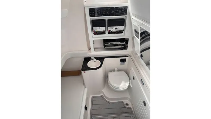 Slide: The Image of 2025 Sea Fox 328 Commander boat interior with toilet and control panels. - 18