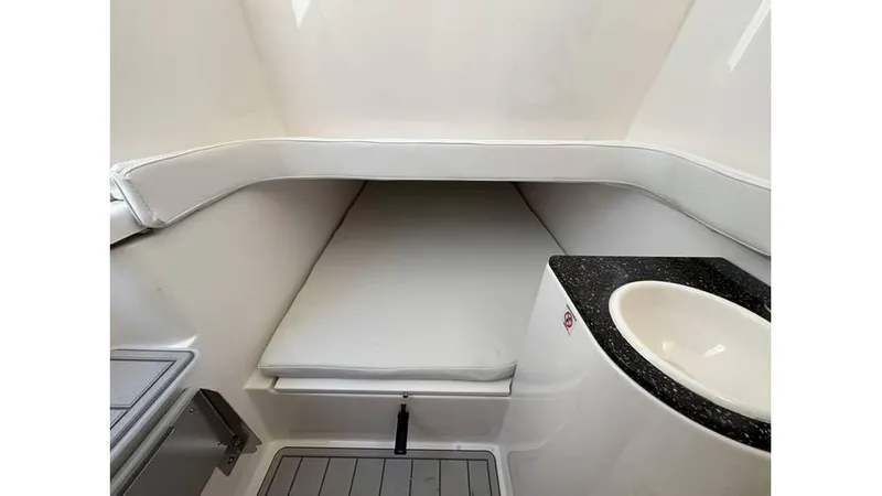 Slide: The Image of 2025 Sea Fox 328 Commander cabin interior with cushioned seating and sink. - 23
