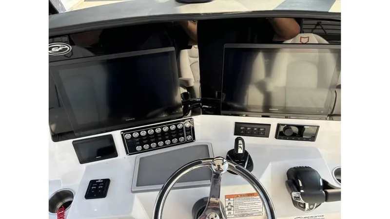 Slide: The Image of 2025 Sea Fox 328 Commander boat dashboard with dual screens and modern controls. - 29