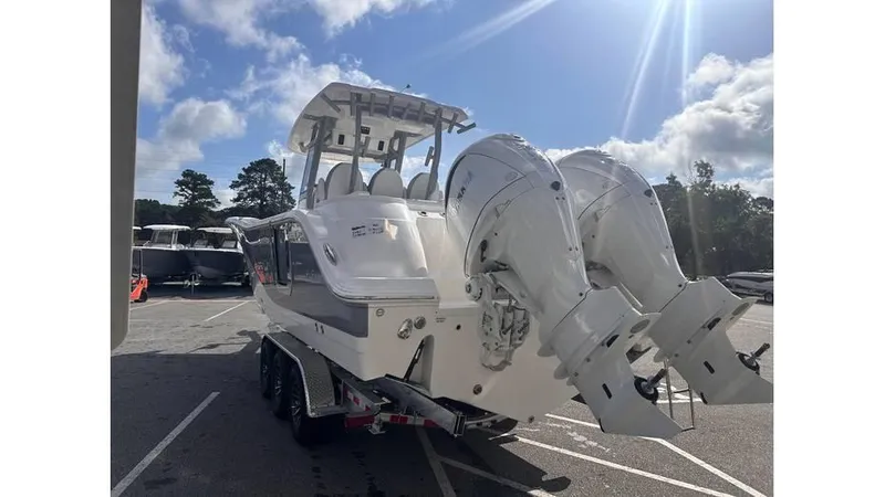 Slide: The Image of 2025 Sea Fox 328 Commander boat with twin outboard engines in a parking lot. - 3