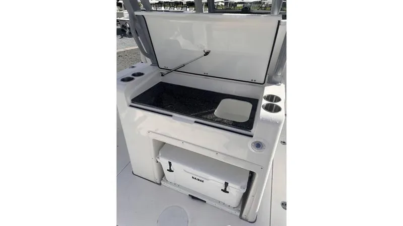 Slide: The Image of 2025 Sea Fox 328 Commander boat with open storage compartment and cooler. - 8