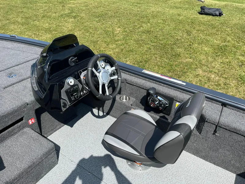 Slide: The Image of 2025 Lund 2075 Pro-V Bass XS boat interior with steering wheel and seat. - 10