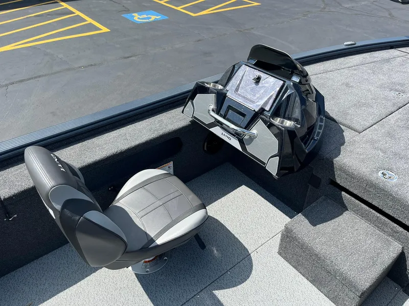 Slide: The Image of 2025 Lund 2075 Pro-V Bass XS boat interior with seating and control panel. - 11