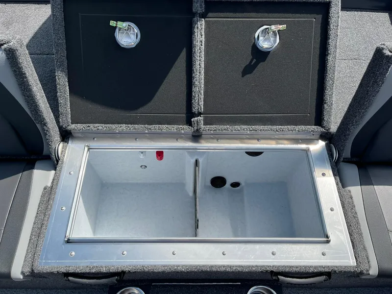 Slide: The Image of 2025 Lund 2075 Pro-V Bass XS livewell compartment with dual lids and secure latches. - 14