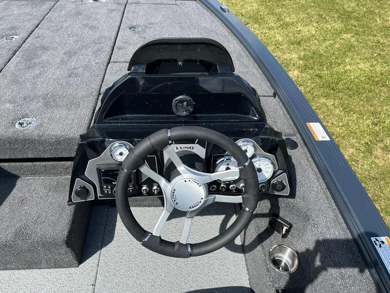 Slide: The Image of 2025 Lund 2075 Pro-V Bass XS boat cockpit with steering wheel and dashboard. - 15