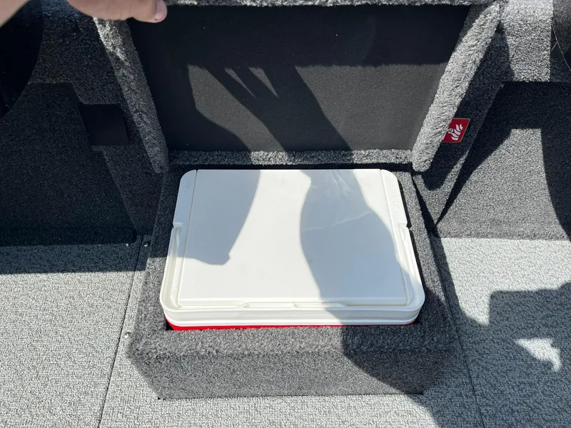 Slide: The Image of 2025 Lund 2075 Pro-V Bass XS storage compartment with a white lid. - 23