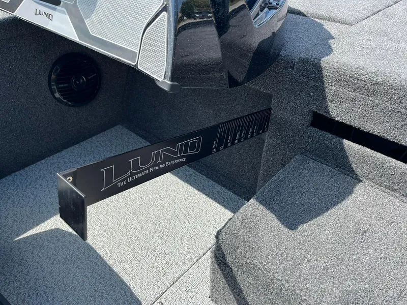 Slide: The Image of 2025 Lund 2075 Pro-V Bass XS boat interior with sleek design and branding. - 25