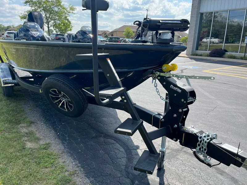 Slide: The Image of 2025 Lund 2075 Pro-V Bass XS boat on trailer in parking lot. - 28