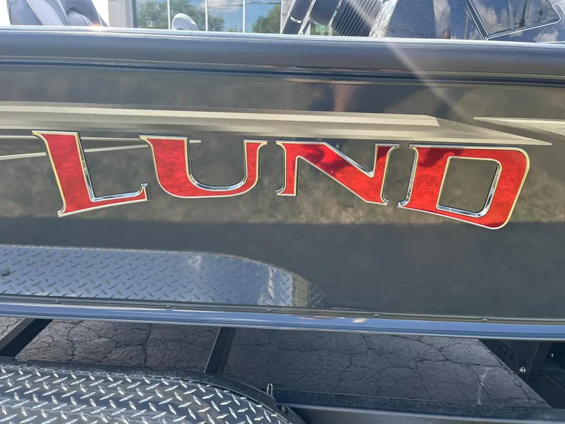 Slide: The Image of Lund 2075 Pro-V Bass XS 2025 boat with red logo on black surface. - 29