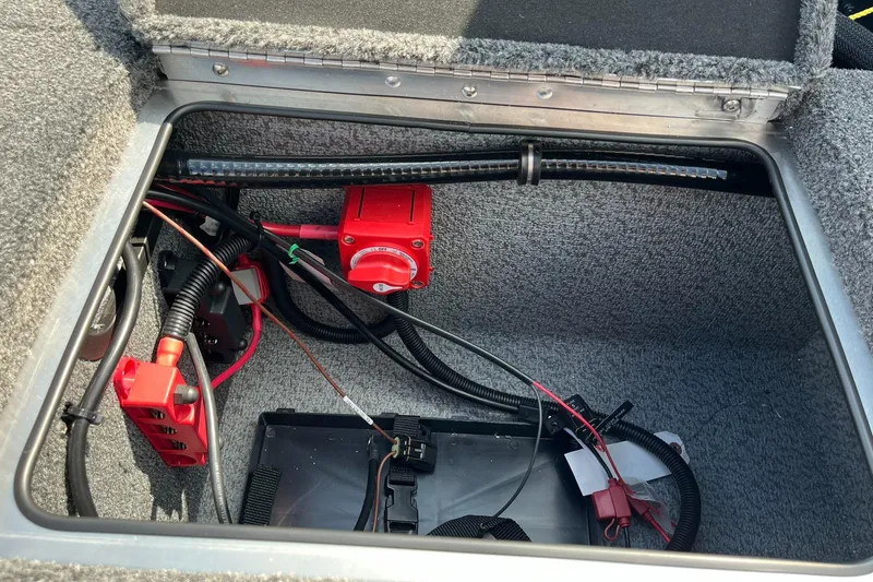 Slide: The Image of 2025 Lund 2075 Pro-V Bass XS battery compartment with wiring and electrical components. - 31