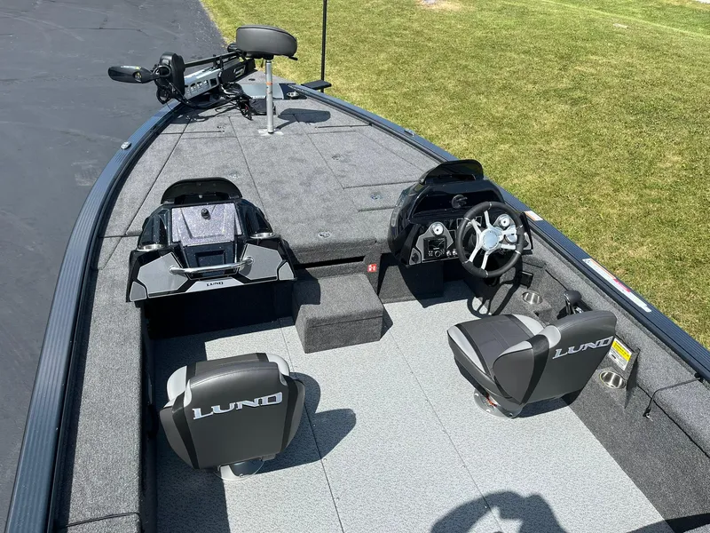 Slide: The Image of 2025 Lund 2075 Pro-V Bass XS boat interior with dual seats and steering console. - 7