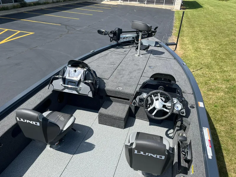 Slide: The Image of 2025 Lund 2075 Pro-V Bass XS boat interior with steering console and seating. - 8