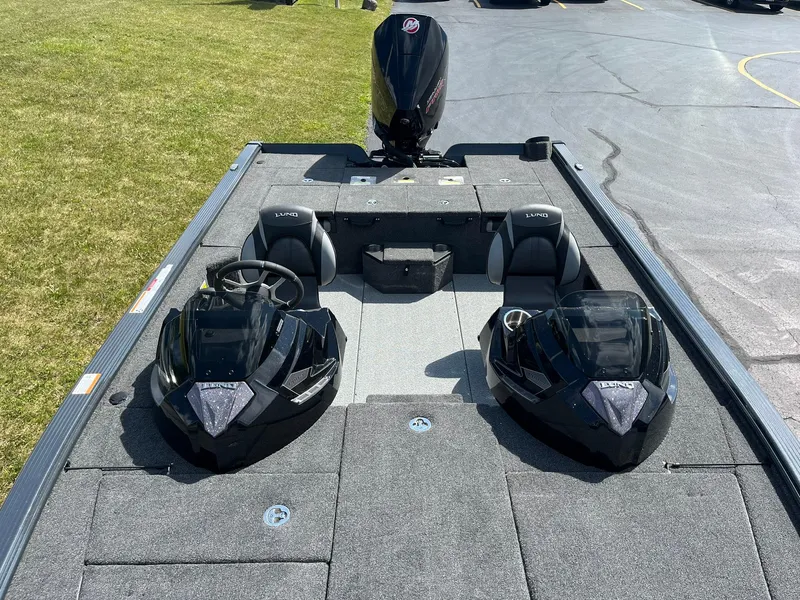 Slide: The Image of 2025 Lund 2075 Pro-V Bass XS boat interior with dual consoles and seating. - 9