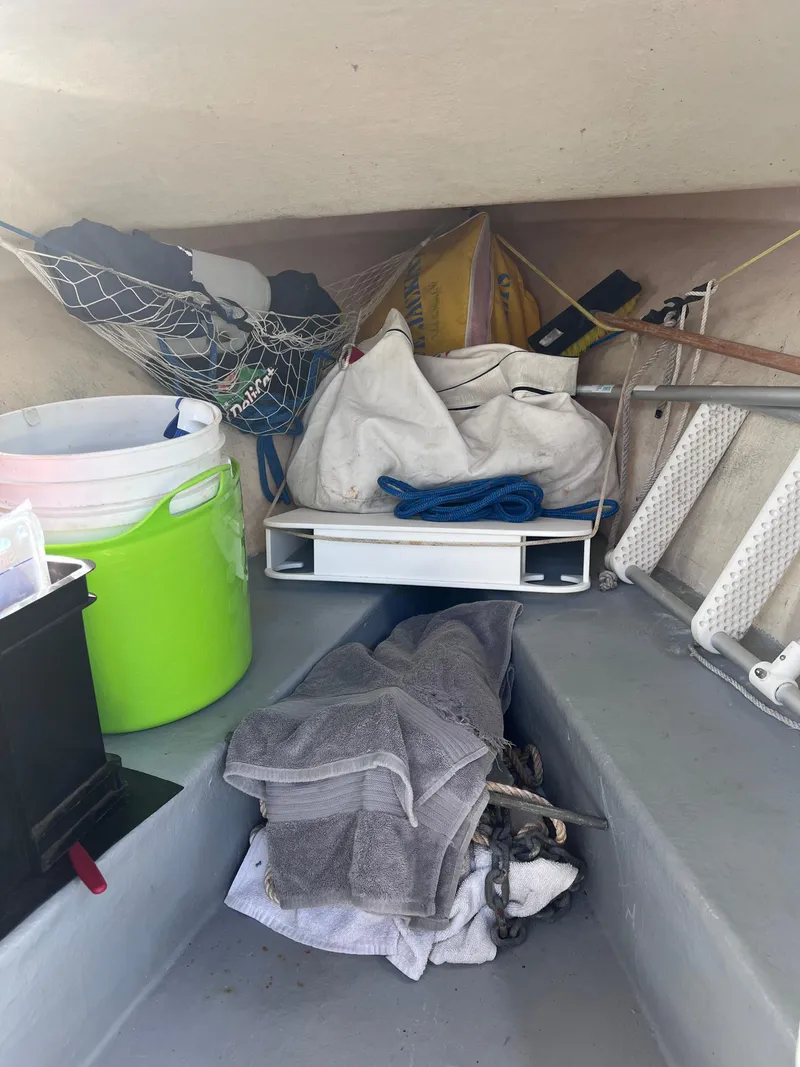 Slide: The Image of Interior of a 1996 Seabreeze 19 Cuddy boat with various stored items. - 11