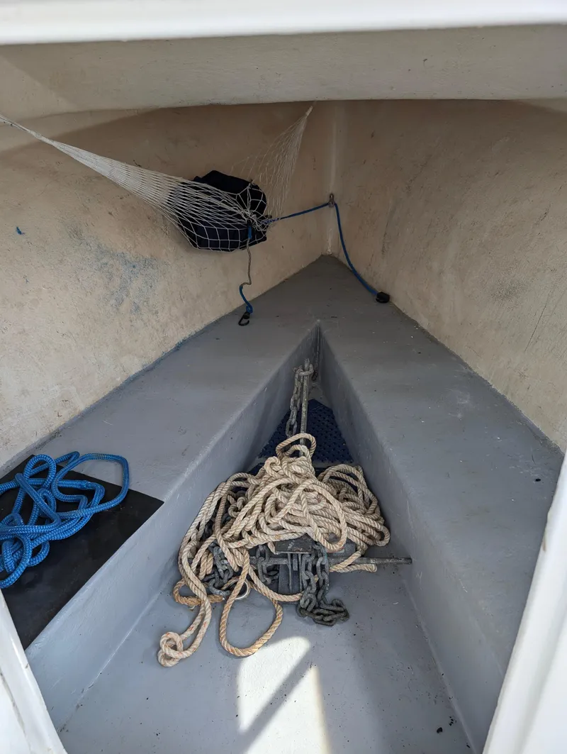 Slide: The Image of 1996 Seabreeze 19 Cuddy interior with ropes and netting. - 3