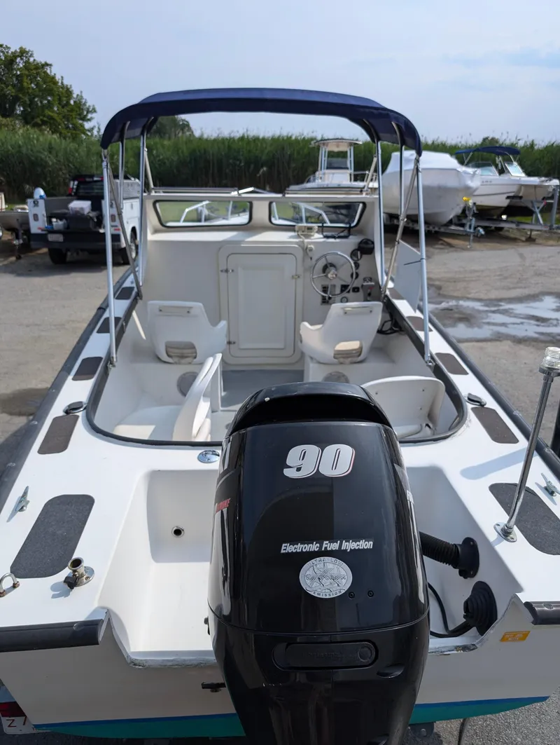 Slide: The Image of 1996 Seabreeze 19 Cuddy boat with 90 HP outboard motor in a marina. - 5