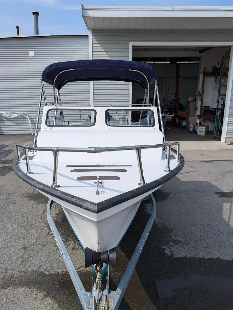 Slide: The Image of 1996 Seabreeze 19 Cuddy boat on trailer in front of a garage. - 6