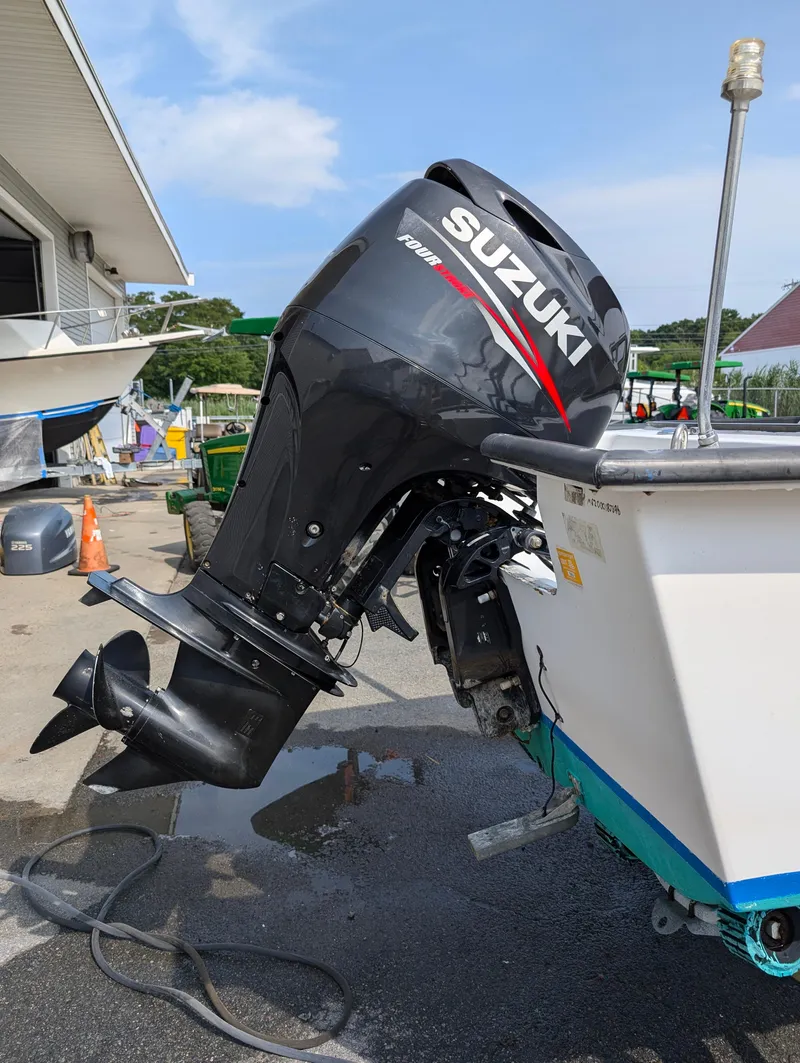 Slide: The Image of 1996 Seabreeze 19 Cuddy with Suzuki outboard motor in a marina. - 7