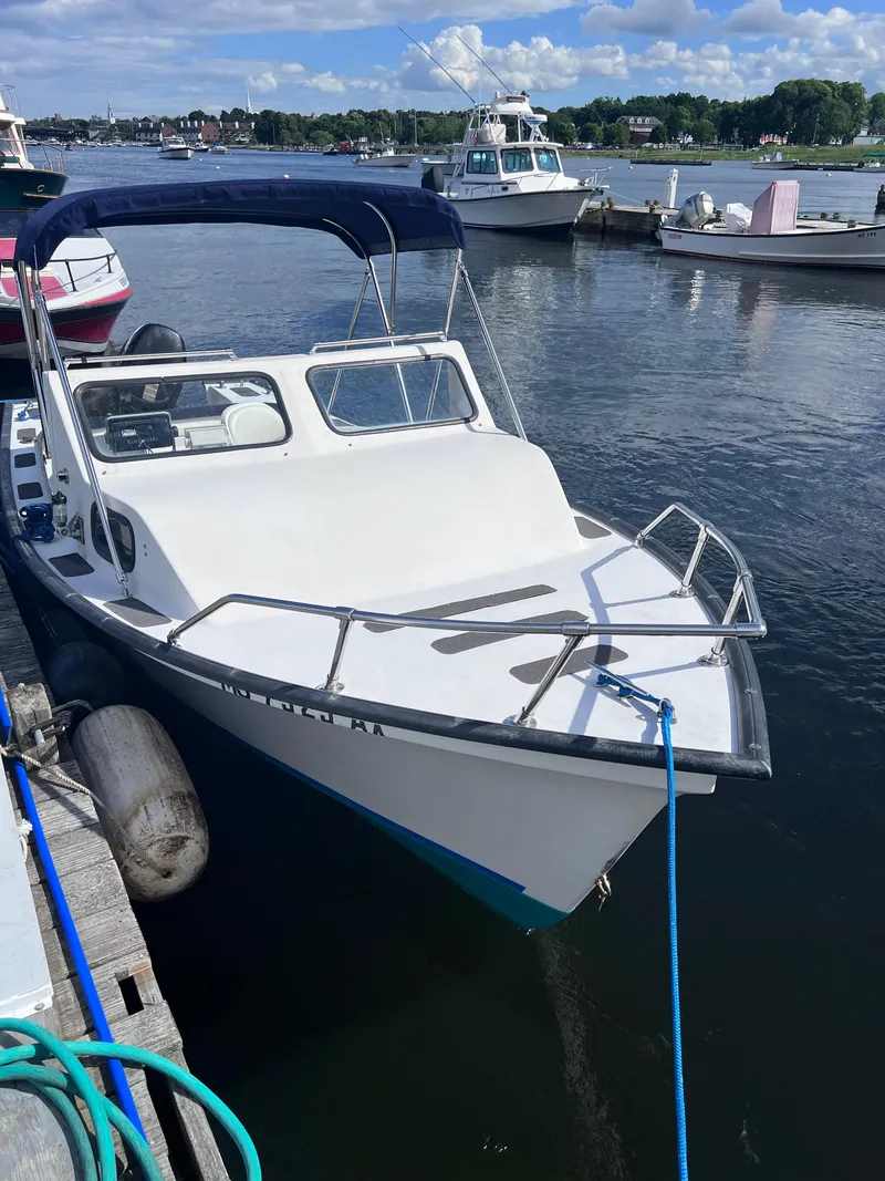 Slide: The Image of 1996 Seabreeze 19 Cuddy boat docked at a marina. - 8