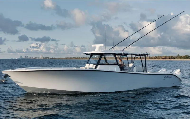 The Image of 2025 Yellowfin 42 Offshore boat cruising on open water under a cloudy sky. - 1