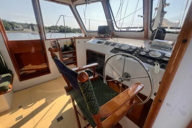 Slide: The Image of Interior of 1996 Custom Bolger PH Shoal-draft Ketch, featuring helm and navigation equipment. - 11