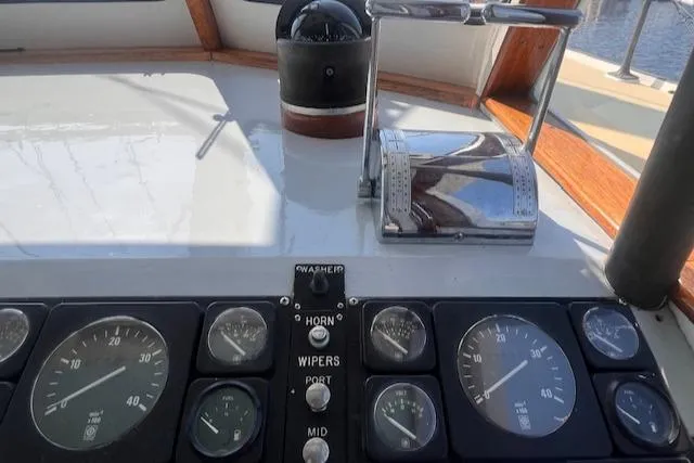 Slide: The Image of Control panel of a 1996 Custom Bolger PH Shoal-draft Ketch with gauges and throttle. - 19