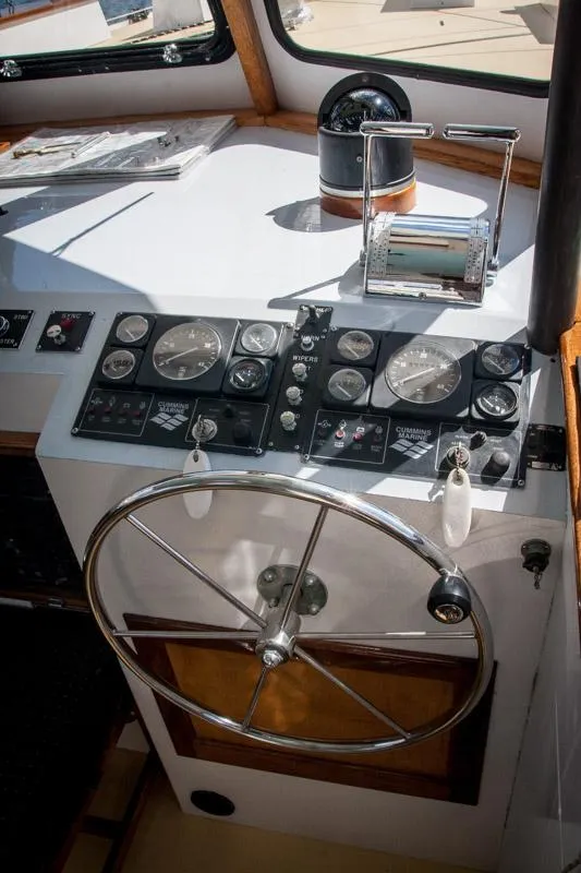 Slide: The Image of 1996 Custom Bolger PH Shoal-draft Ketch helm with steering wheel and navigation instruments. - 2