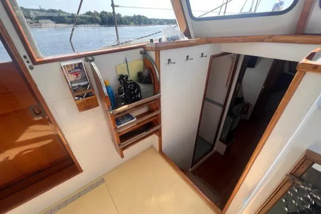 Slide: The Image of Interior of 1996 Custom Bolger PH Shoal-draft Ketch with wooden accents and river view. - 24